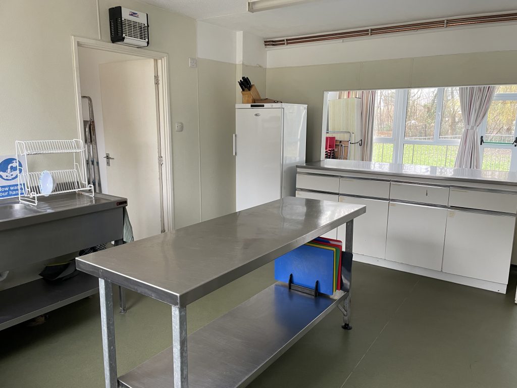 Paxmead Kitchen - Stainless steel work surfaces and serving hatch to main hall